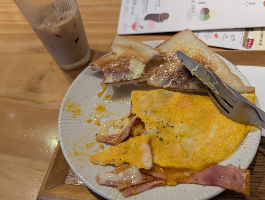 An omelette with an iced coffee and toast
