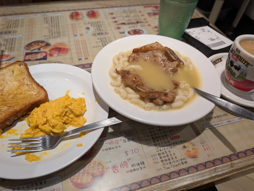 eggs, toast, and a porkchop in macaroni soup